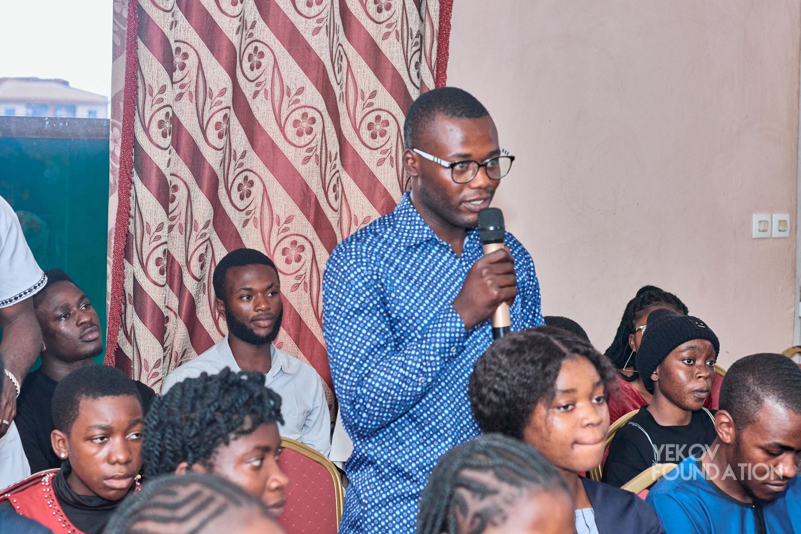 A mentor speaking to a room of young people