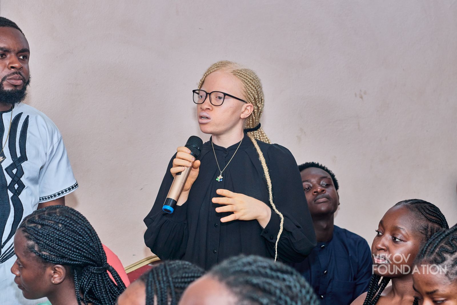 A young woman asking the panel a question
