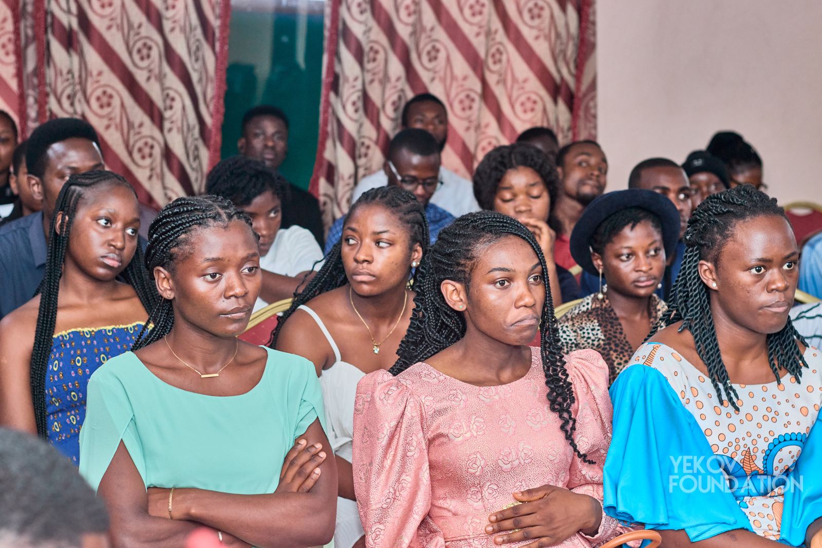 Young women listening attentively during a panel discussion
