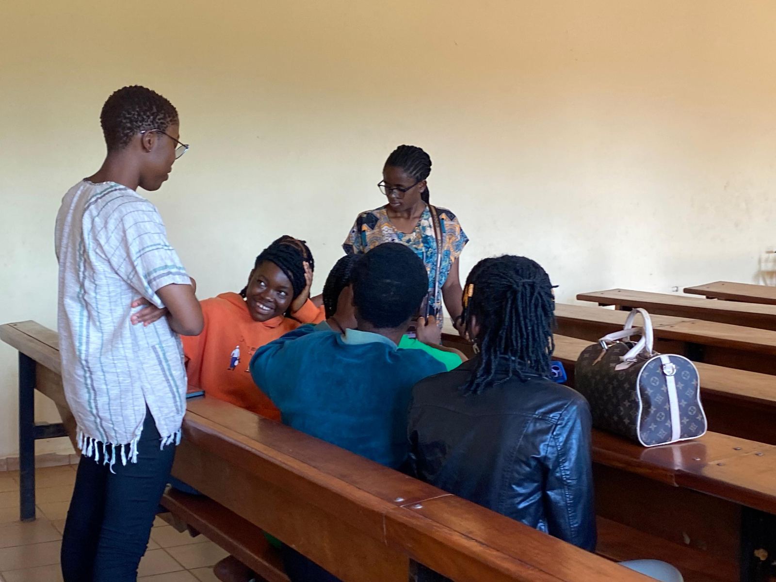 The IT trainer and hairdressing tutor talking with students in a classroom